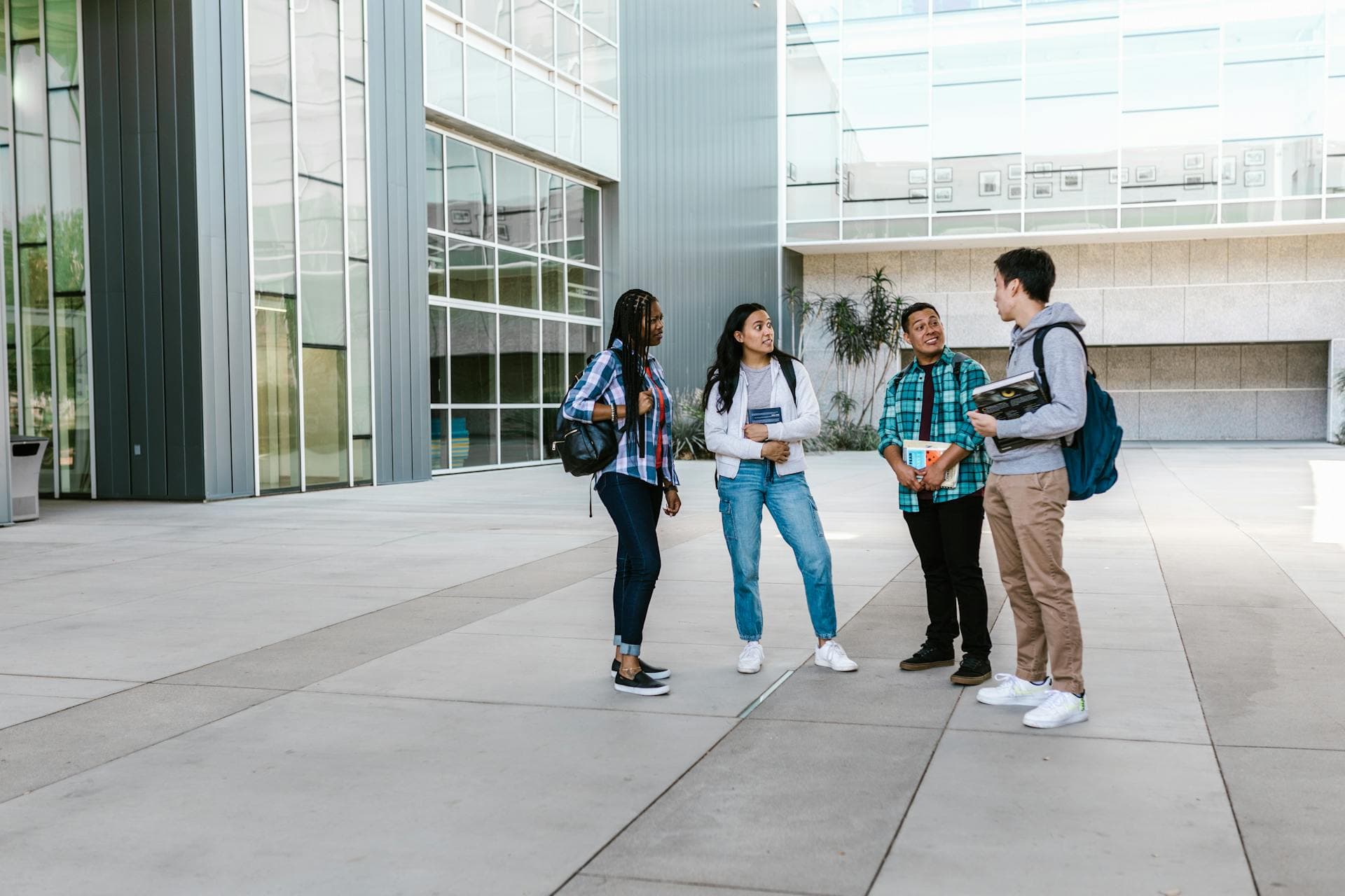 Students walking toward a modern university campus building